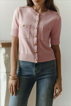 Clara Pink short-sleeve knit cardigan shown in a full-body view with a round neckline, ribbed hem, and fitted shape