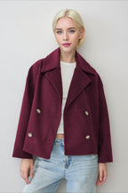 Clara Red cropped double-breasted coat featuring wide notched lapels, a relaxed boxy fit, long sleeves, and double-row button closure