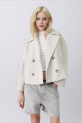 Clara White cropped double-breasted coat with wide lapels, long sleeves, relaxed fit, and double-breasted button-front styling