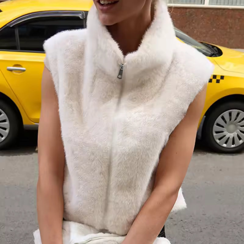 Clara White sleeveless faux-fur vest with stand collar and front zip closure, shown in a close styled view