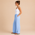Side view of the Cleo Lightweight Linen Wide-Leg Summer Pants in blue, showcasing the relaxed fit and flowing wide-leg design. Designed by Bella Hudson.