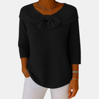 Front view of the Colette Bow-Tie Long Sleeve T-shirt in black, featuring a decorative bow neckline, ribbed texture, three-quarter sleeves, and a timeless relaxed silhouette. Designed by Bella Hudson.