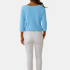 Back view of the Colette Bow-Tie Long Sleeve T-shirt in blue, featuring a clean back design, three-quarter sleeves, ribbed knit texture, and a relaxed silhouette. Designed by Bella Hudson.