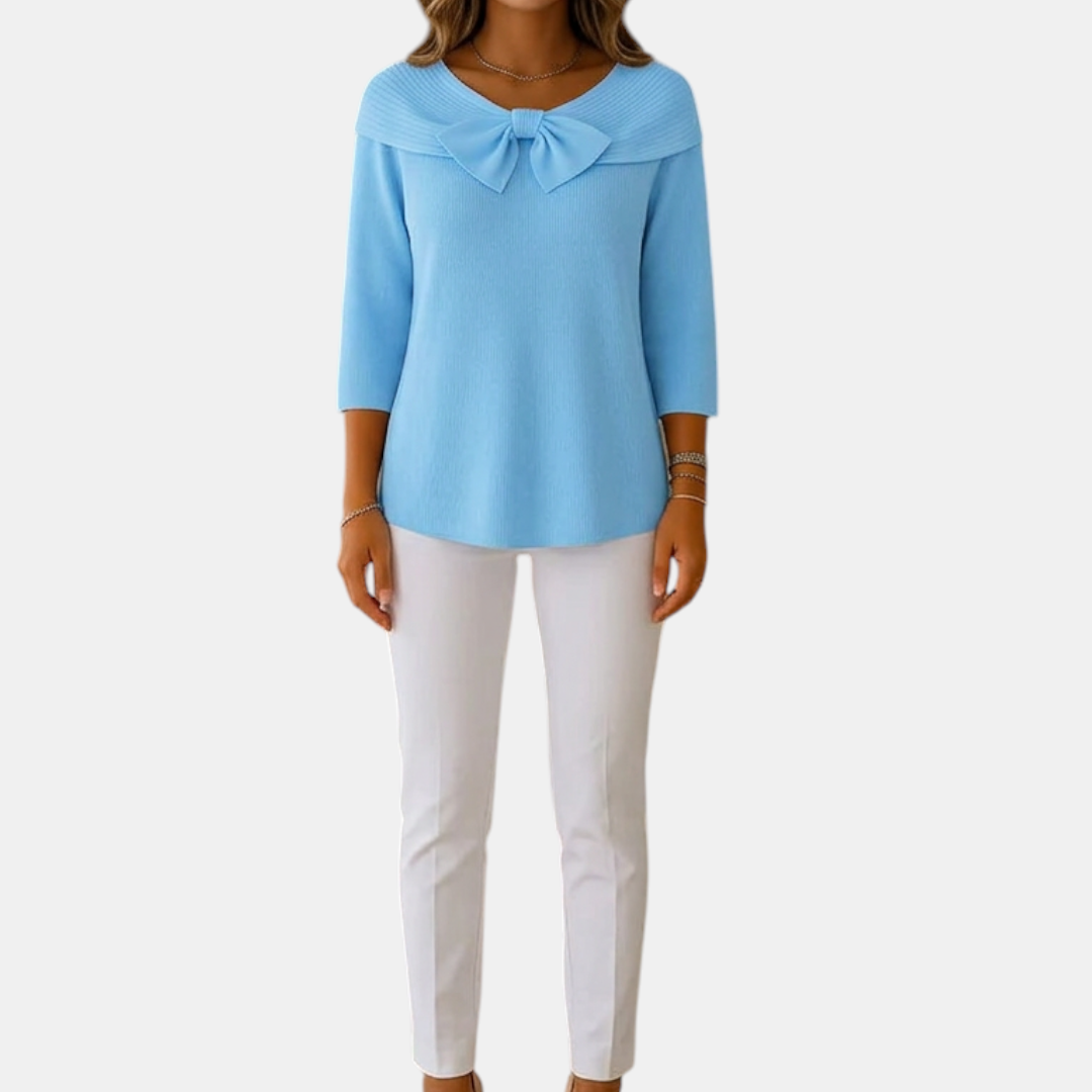 Full front view of the Colette Bow-Tie Long Sleeve T-shirt in blue, showcasing the bow neckline, ribbed texture, three-quarter sleeves, and relaxed everyday silhouette. Designed by Bella Hudson.