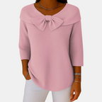 Front view of the Colette Bow-Tie Long Sleeve T-shirt in pink, featuring a decorative bow neckline, ribbed texture, three-quarter sleeves, and a relaxed curved hem. Designed by Bella Hudson.