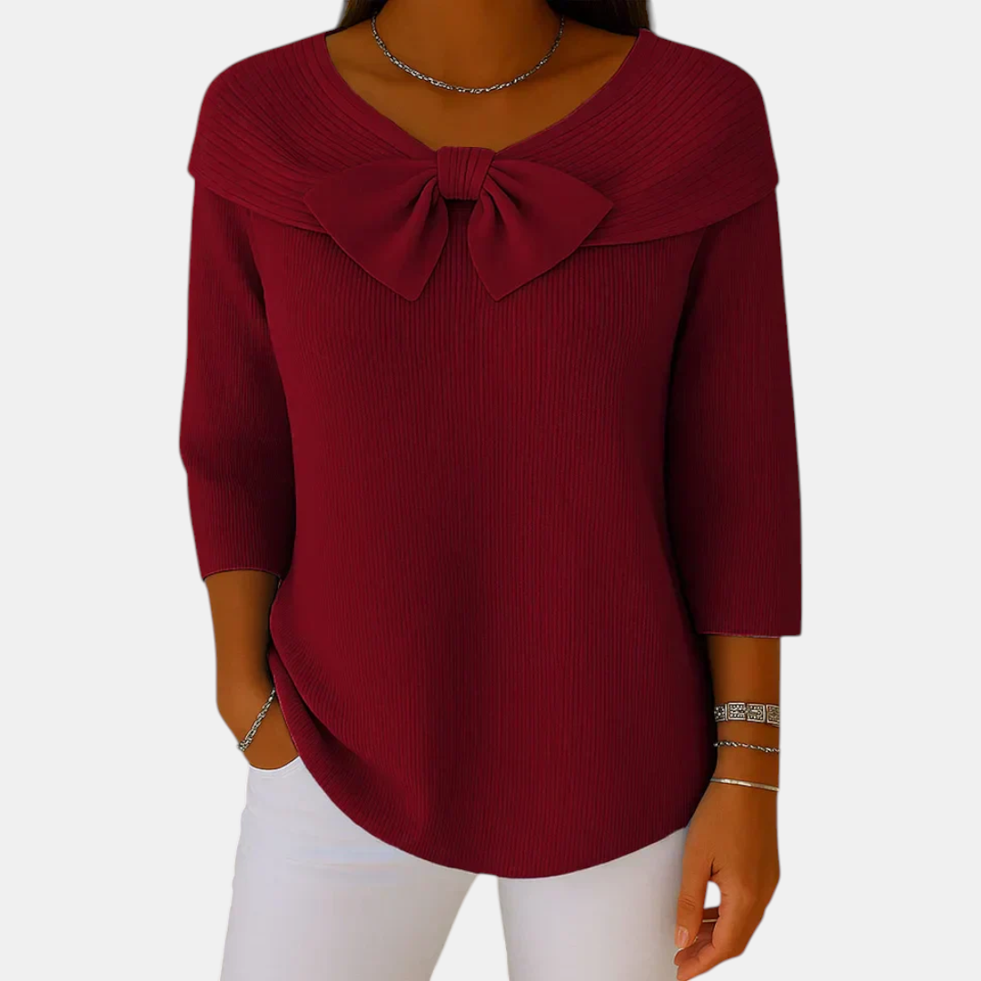 Front view of the Colette Bow-Tie Long Sleeve T-shirt in red, featuring a decorative bow neckline, ribbed fabric, three-quarter sleeves, and a flattering relaxed silhouette. Designed by Bella Hudson.