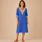 Front view of the Cora Midi Dress Lightweight Linen V-Neck Summer in blue, featuring lightweight linen fabric, decorative crochet V-neck trim, and a relaxed midi silhouette. Designed by Bella Hudson.