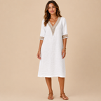 Front view of the Cora Midi Dress Lightweight Linen V-Neck Summer in white, featuring a relaxed linen silhouette, elegant V-neck with crochet trim, and three-quarter sleeves. Designed by Bella Hudson.