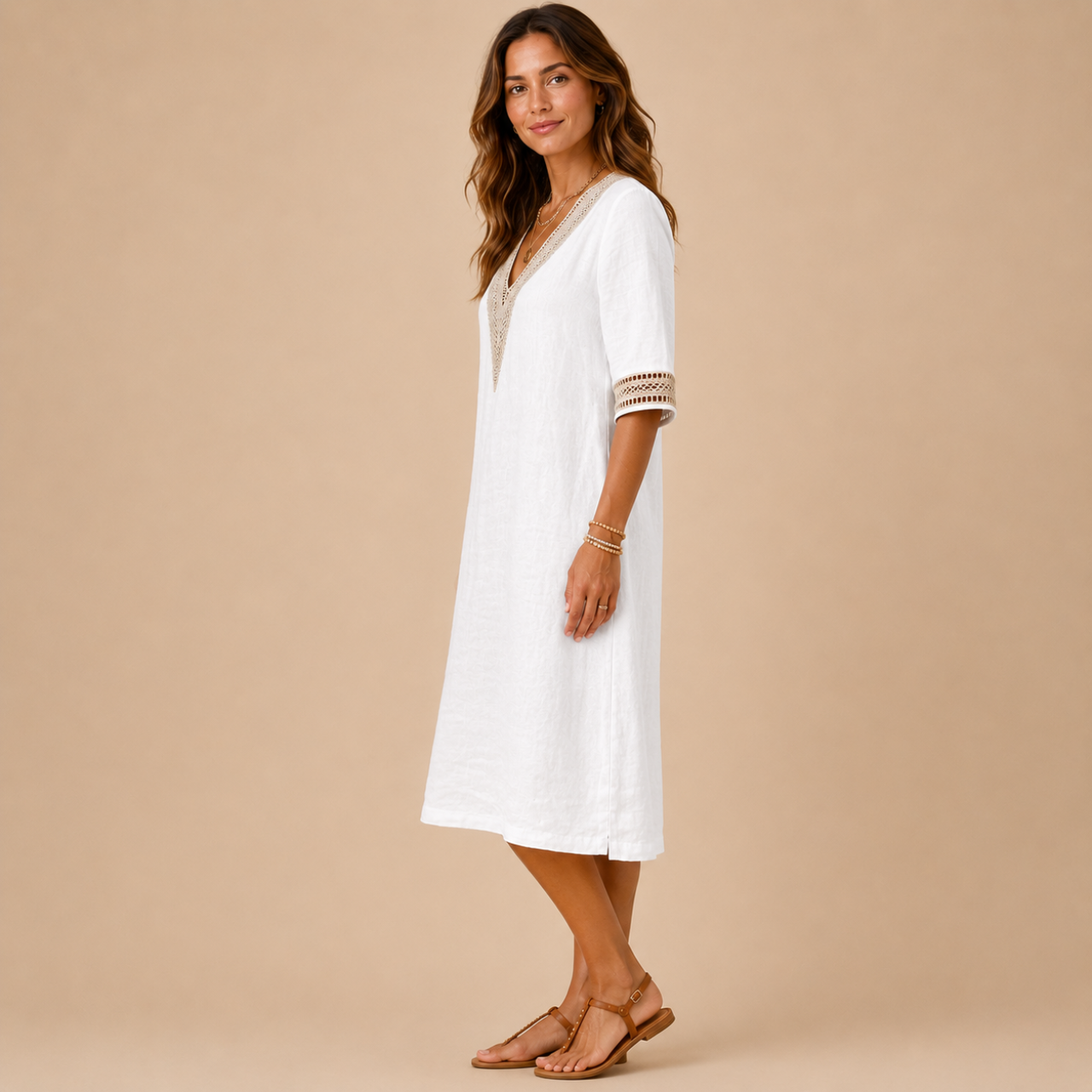 Side view of the Cora Midi Dress Lightweight Linen V-Neck Summer in white, showcasing the relaxed straight fit, lightweight linen fabric, and flattering midi length. Designed by Bella Hudson.