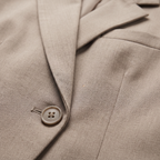 Coralie Taupe double-breasted blazer close-up of the peak lapel, button, and fabric texture.