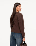 Dahlia Dark Brown cardigan shown from the back three-quarter angle, with a shaped back seam and balloon sleeves.