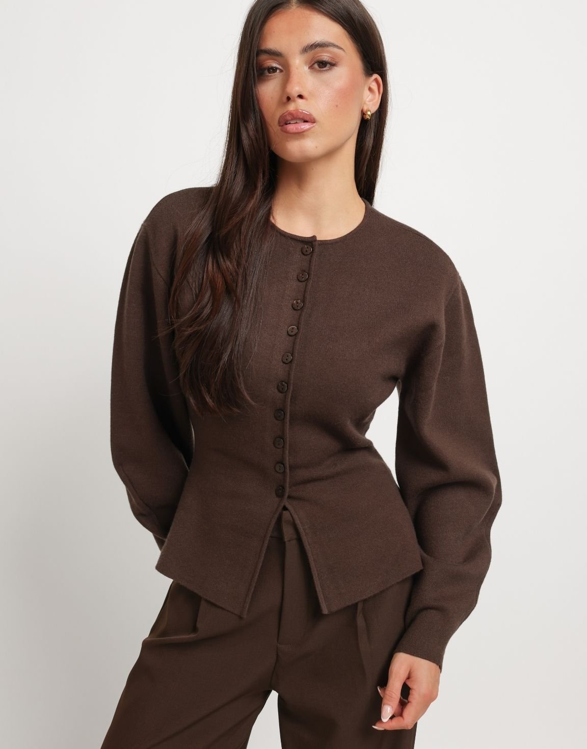 Dahlia Dark Brown button-front cardigan shown close-up on a model with a round neckline, balloon sleeves, and a cinched waist.