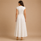 Back view of the Darcy Polka Dot Maxi Dress featuring a fitted bodice and flowing A-line maxi skirt. Designed by Bella Hudson.