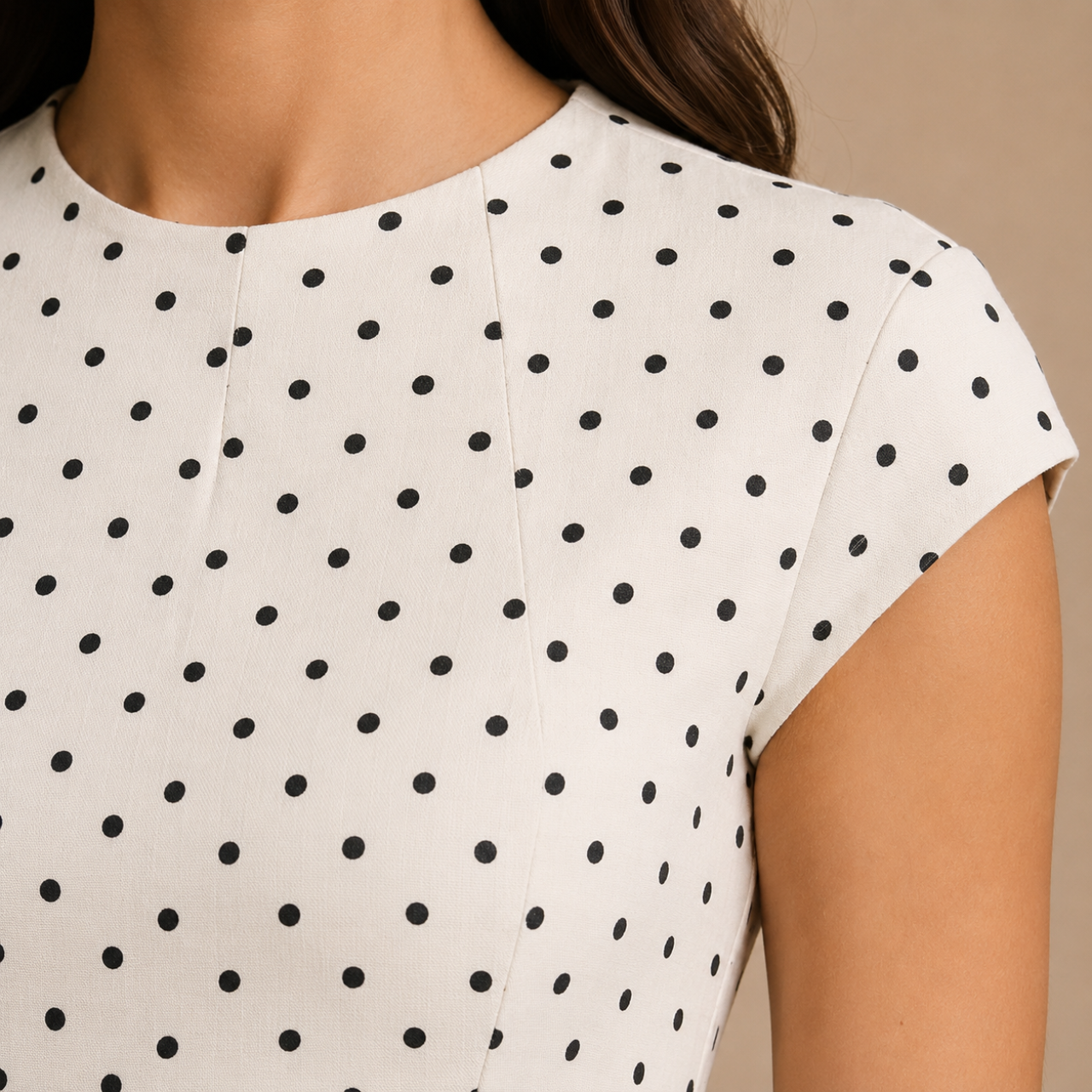 Close-up detail of the Darcy Polka Dot Maxi Dress highlighting the round neckline and polka dot print. Designed by Bella Hudson.