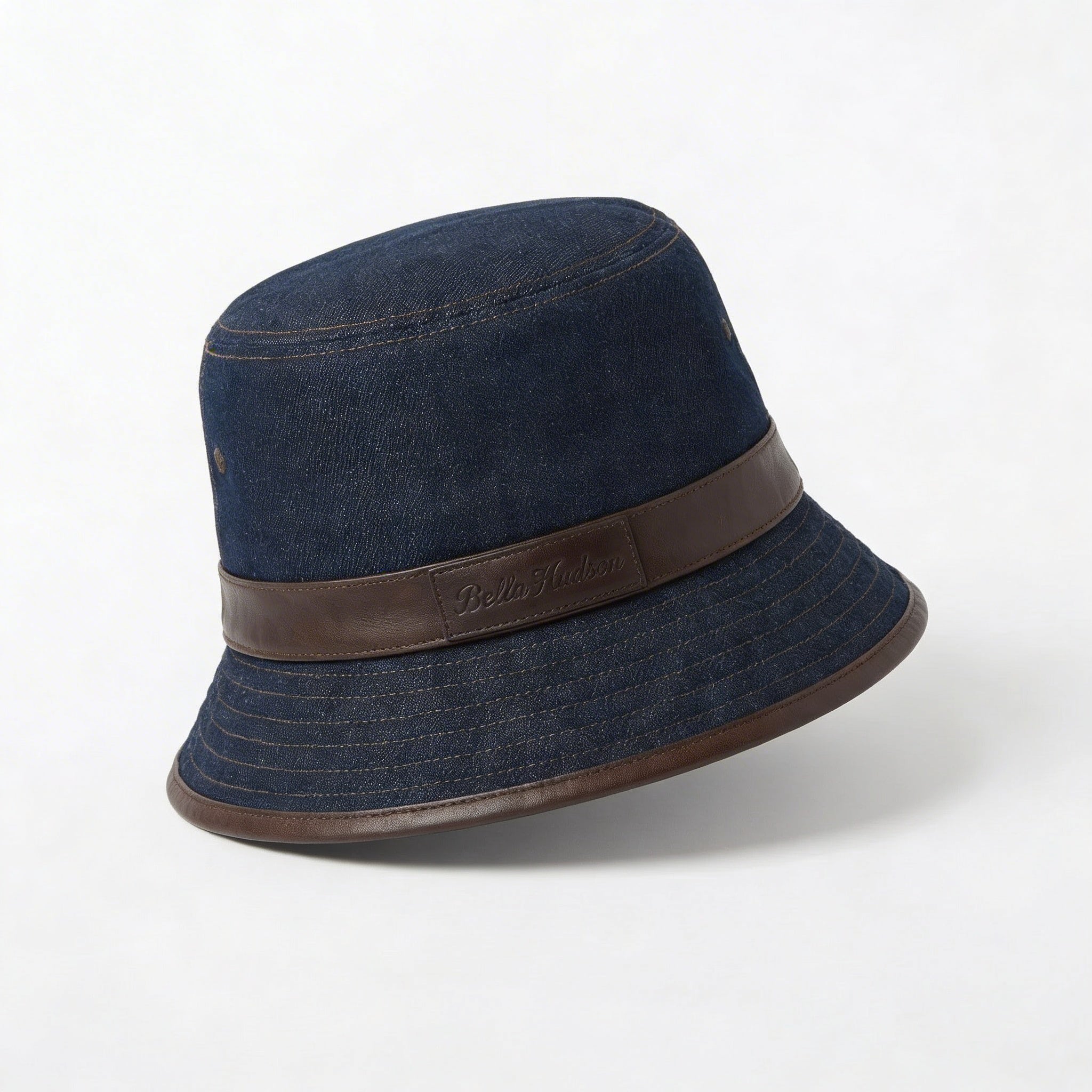 Dark blue denim bucket hat with leather band angled side view BELLA HUDSON