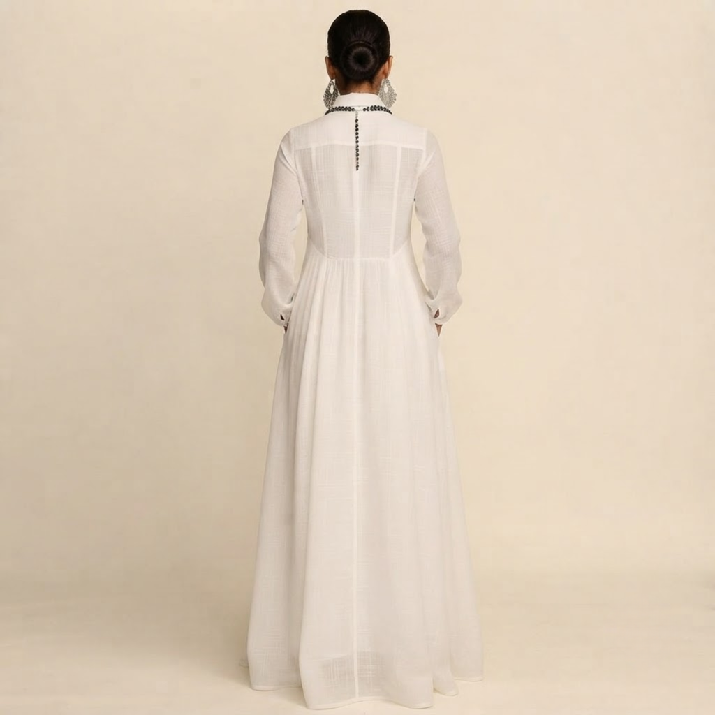 Back view of the Delphine Maxi Dress Linen Button-Front Long-Sleeve in White, highlighting the graceful maxi silhouette and comfortable fit. Designed by Bella Hudson.