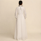 Back view of the Delphine Maxi Dress Linen Button-Front Long-Sleeve in White, highlighting the graceful maxi silhouette and comfortable fit. Designed by Bella Hudson.