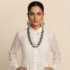 Close-up front view of the Delphine Maxi Dress Linen Button-Front Long-Sleeve in White, showcasing the button-front detailing, long sleeves, and elegant neckline. Designed by Bella Hudson.