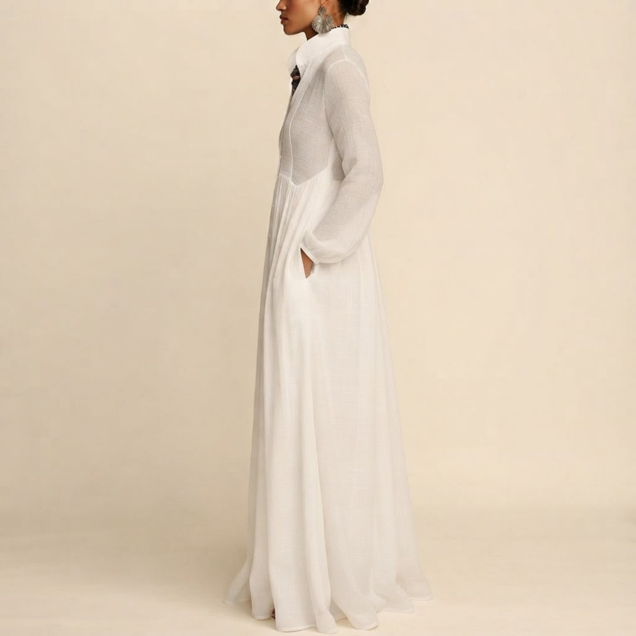 Side view of the Delphine Maxi Dress Linen Button-Front Long-Sleeve in White, showcasing the elegant long sleeves and flowing maxi silhouette. Designed by Bella Hudson.