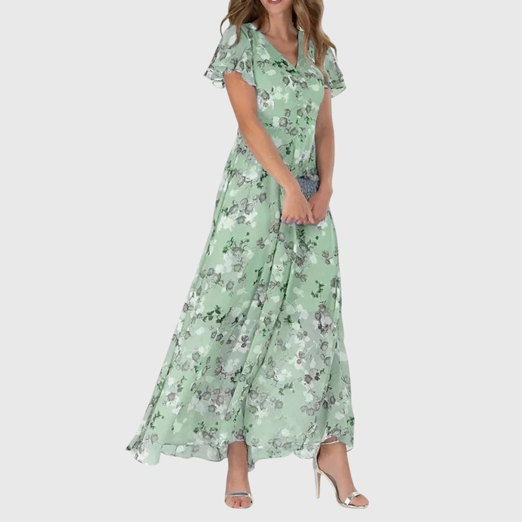 Front view of the Delphine Summer Maxi Dress Floral Print Flutter Sleeve in green, featuring flutter sleeves, a V-neckline, floral print, and a graceful flowing maxi-length design. Designed by Bella Hudson.