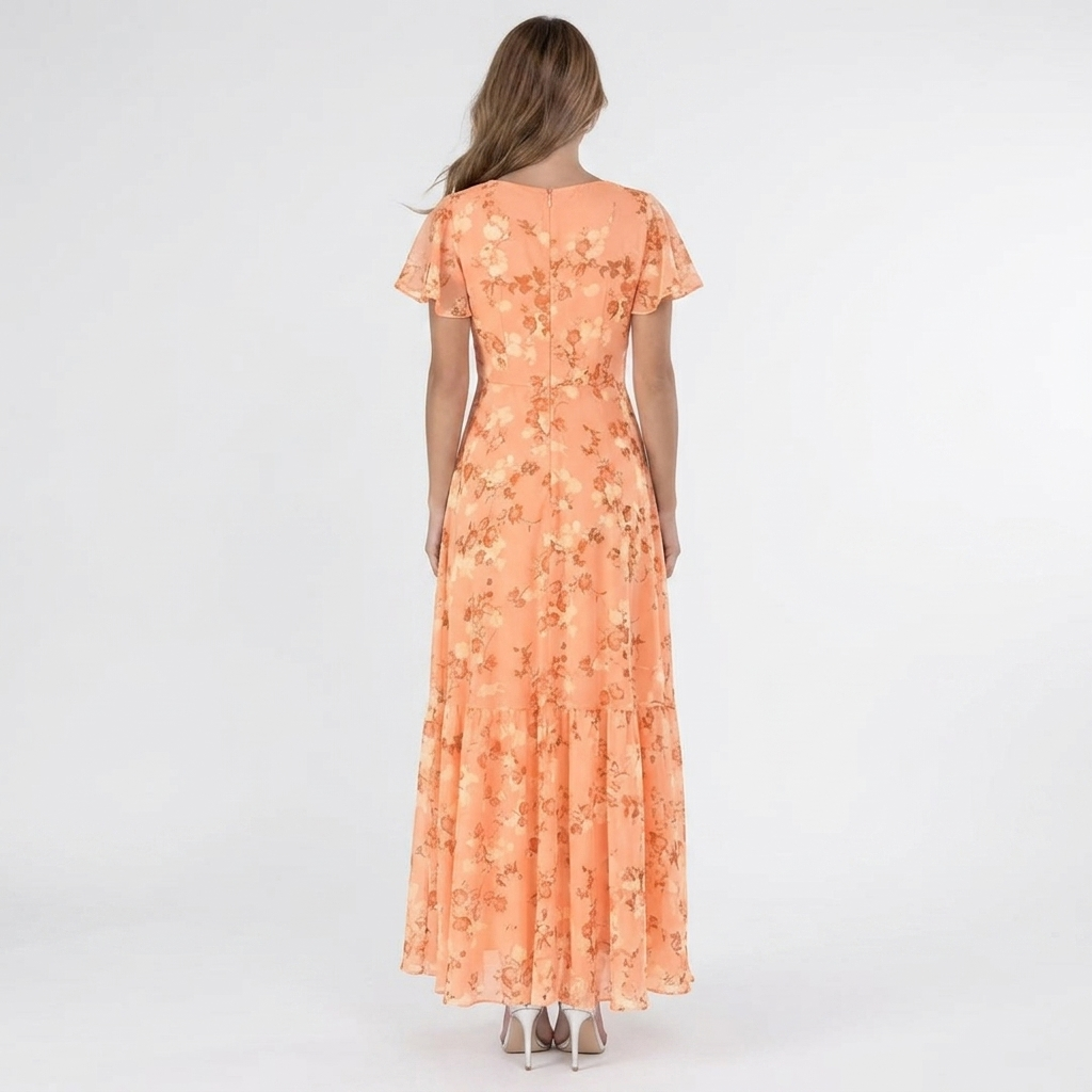 Back view of the Delphine Summer Maxi Dress Floral Print Flutter Sleeve in orange, highlighting the flowing tiered skirt, flutter sleeves, and elegant floral pattern. Designed by Bella Hudson.
