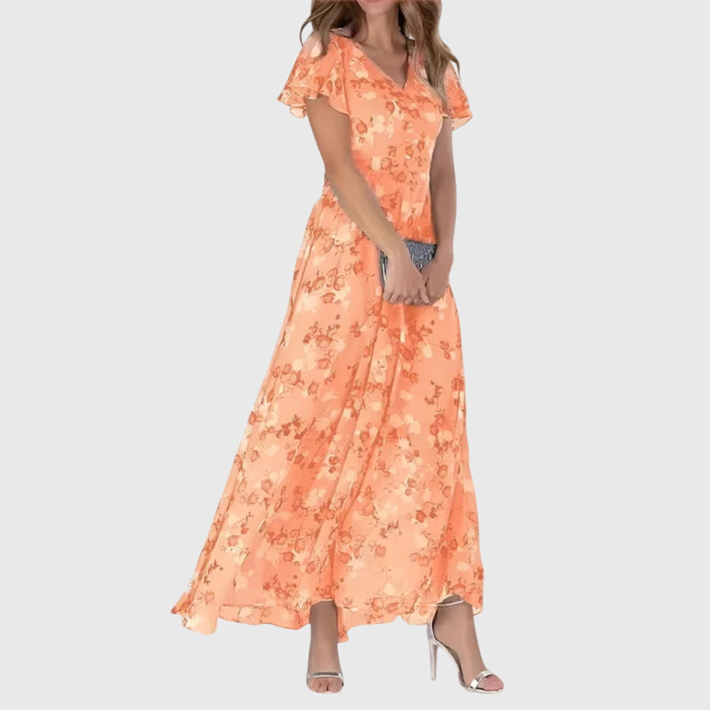 Front view of the Delphine Summer Maxi Dress Floral Print Flutter Sleeve in orange, featuring a V-neckline, flutter sleeves, floral print, tiered maxi skirt, and a flowing feminine silhouette. Designed by Bella Hudson.