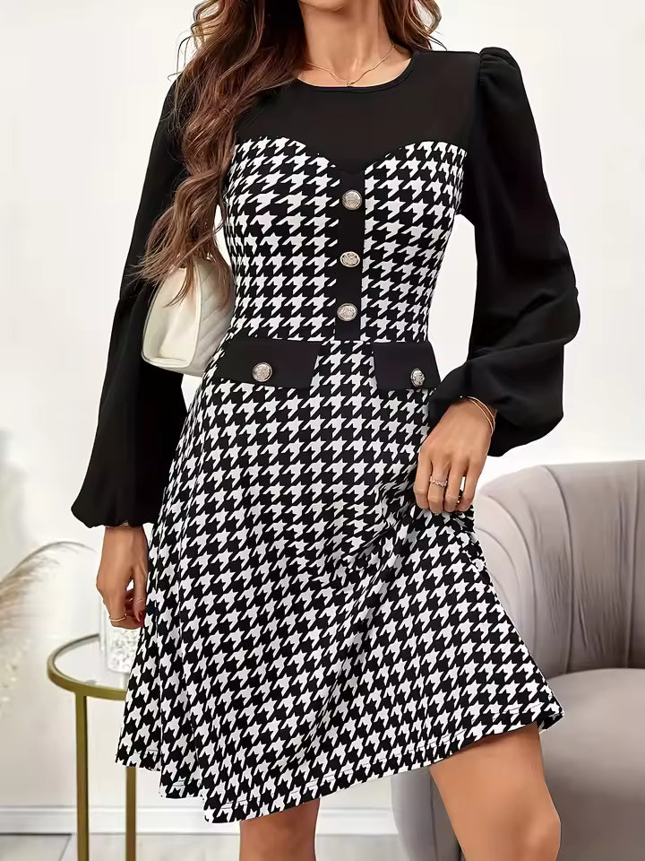 Diana Black houndstooth mini dress with round neckline, decorative buttons, long puff sleeves, and flared skirt