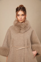 Elara Brown faux-fur trim cape coat highlighting the plush faux-fur collar, cuff trim, slim waist belt, and side pocket