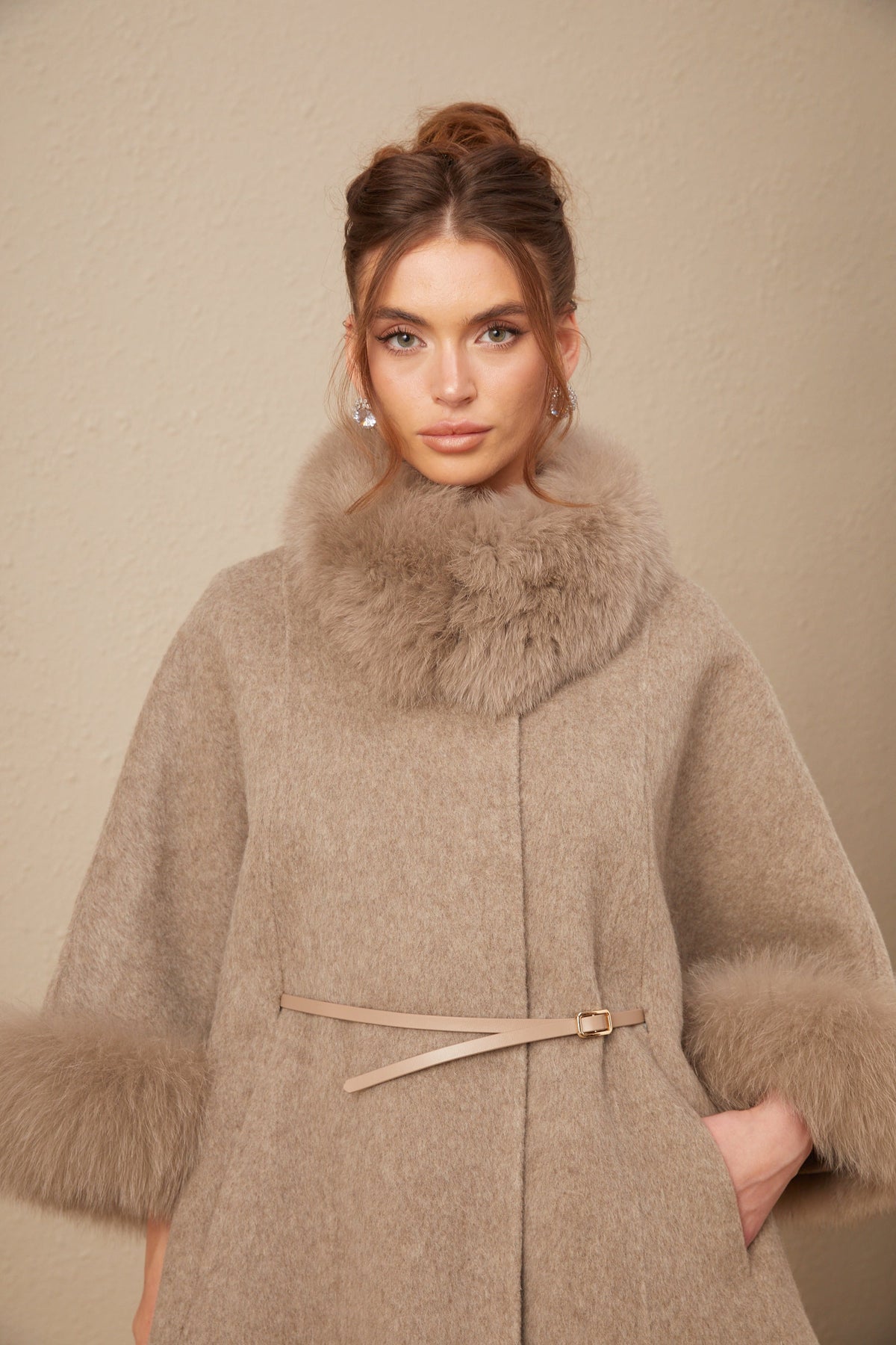 Elara Brown faux-fur trim cape coat highlighting the plush faux-fur collar, cuff trim, slim waist belt, and side pocket