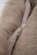 Elara Brown faux-fur trim cape coat close-up showing the plush faux-fur texture and fastening detail