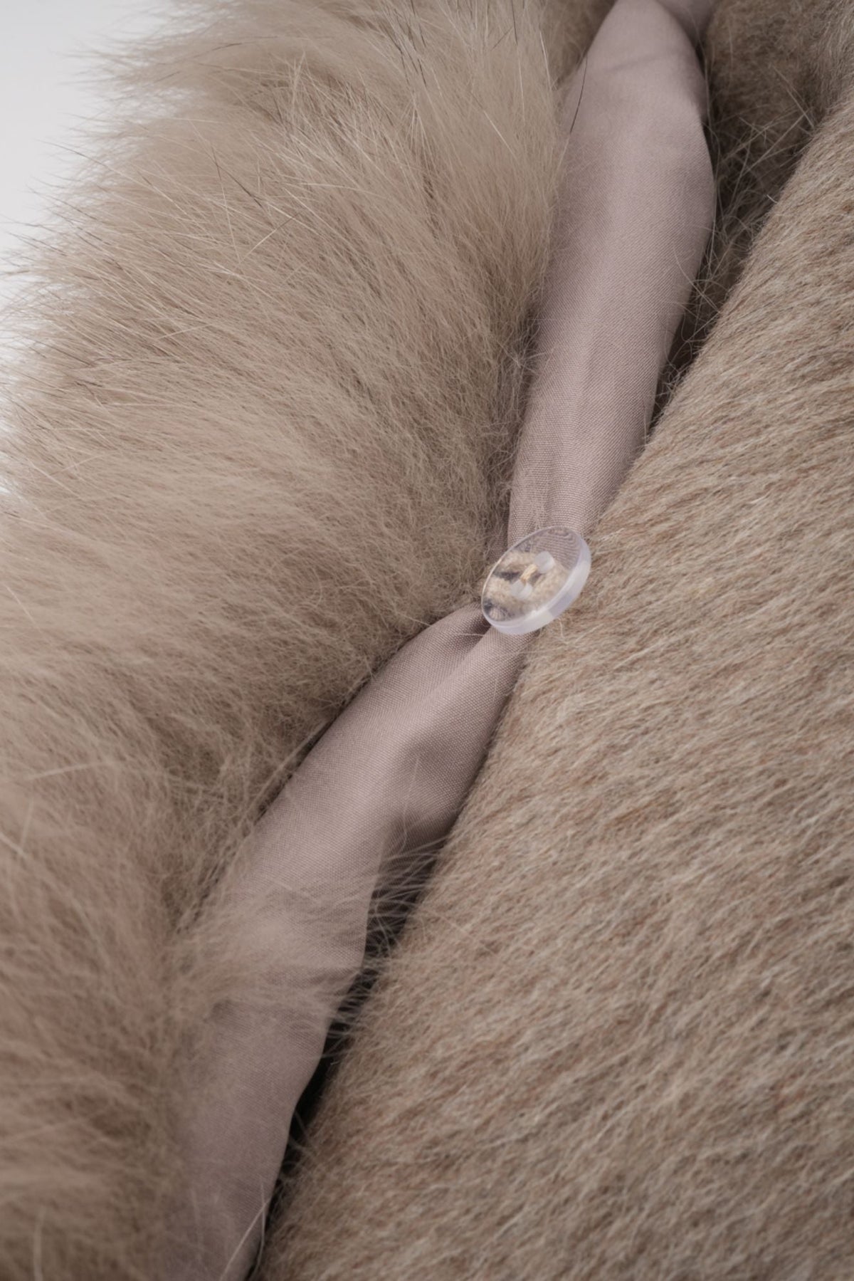 Elara Brown faux-fur trim cape coat close-up showing the plush faux-fur texture and fastening detail