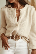 Elara White openwork knit cardigan with crew neck and button front, styled with white jeans and a brown belt.