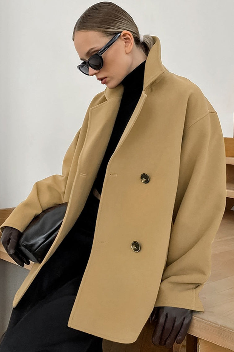 Elena Beige double-breasted boxy jacket shown from the side with notched lapels and a relaxed silhouette