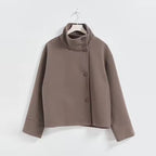 Elena Brown short coat featuring a stand collar, double-breasted button front, dropped shoulders, and relaxed silhouette