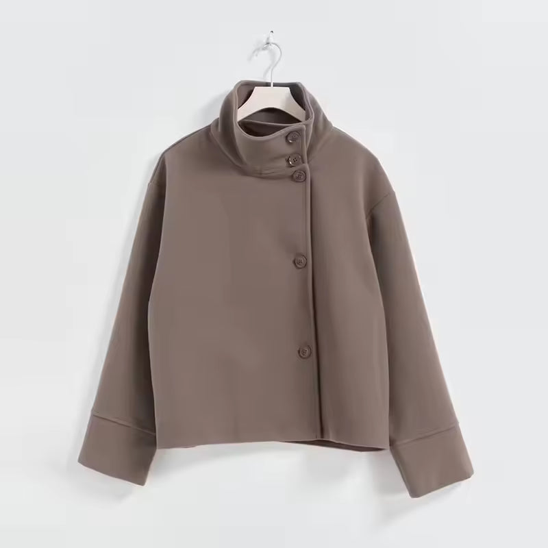 Elena Brown short coat featuring a stand collar, double-breasted button front, dropped shoulders, and relaxed silhouette