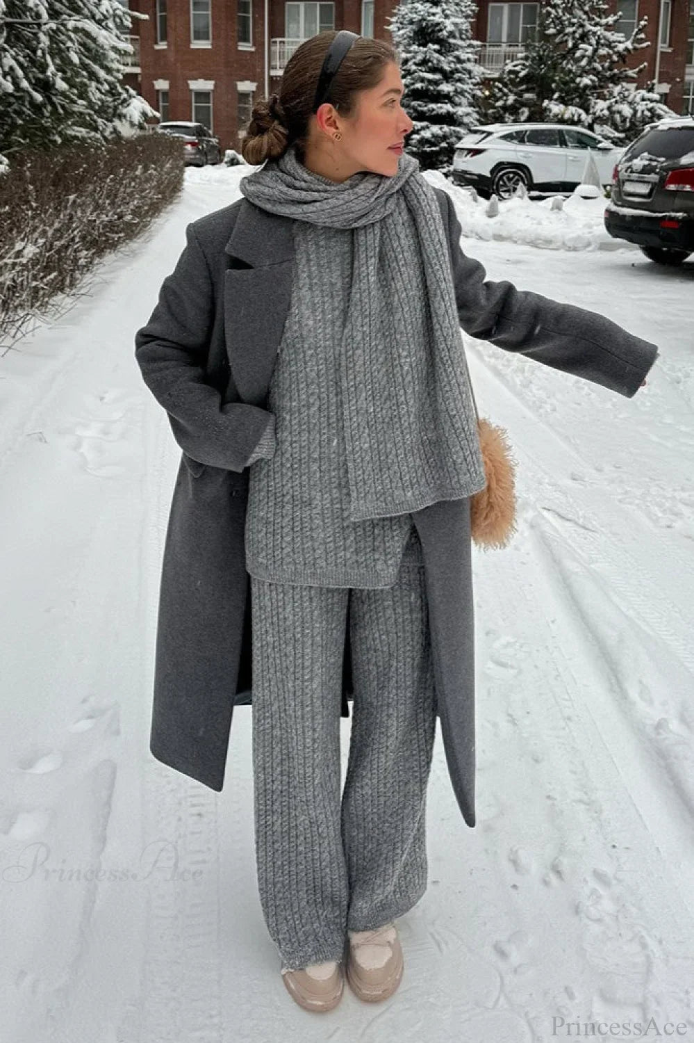 Elena Gray cable-knit sweater, wide-leg pants, and scarf styled with a long charcoal coat.
