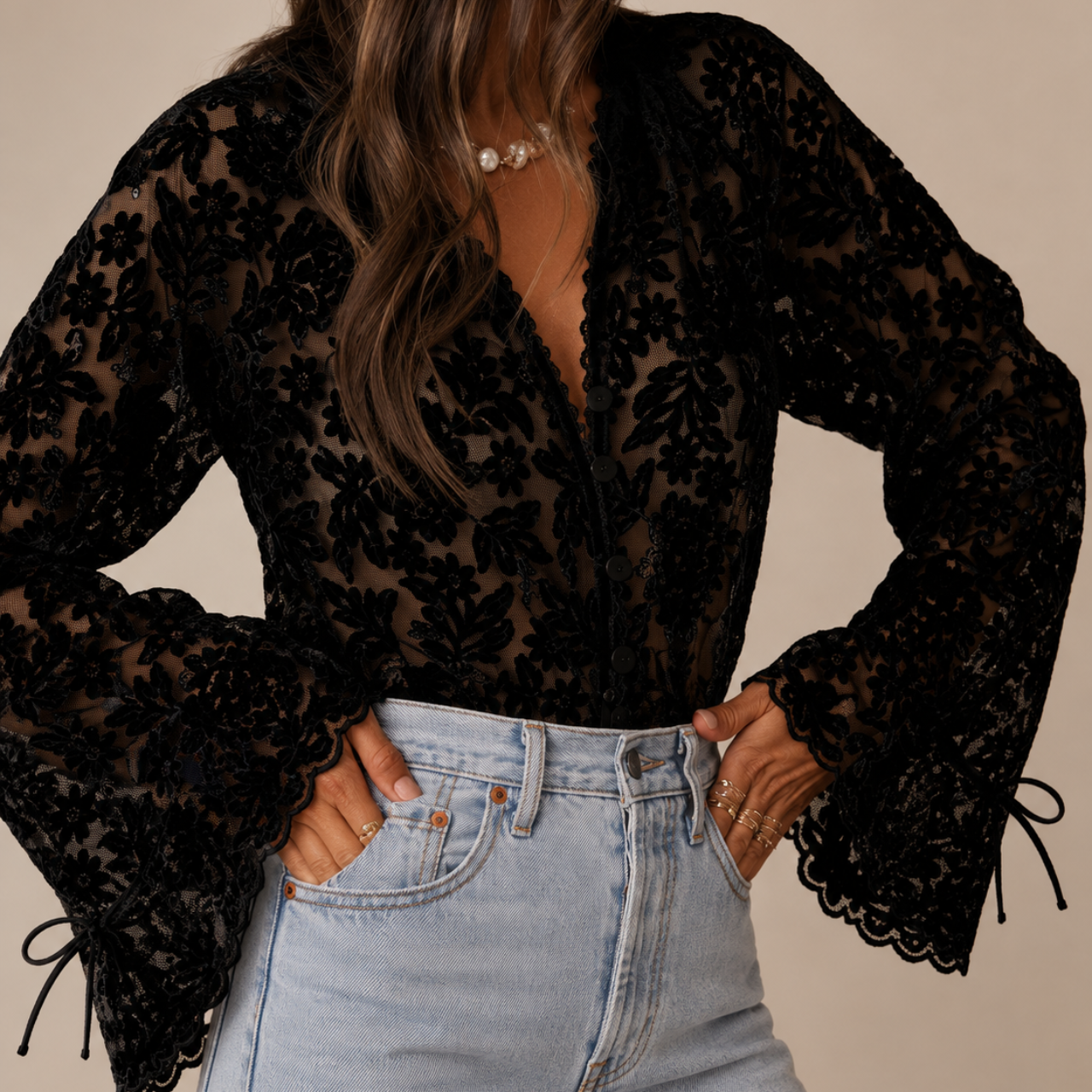 Front view of Elia Floral Lace Long Sleeve Blouse in Black featuring floral lace detailing, a V-neckline, and elegant long sleeves designed by Bella Hudson.