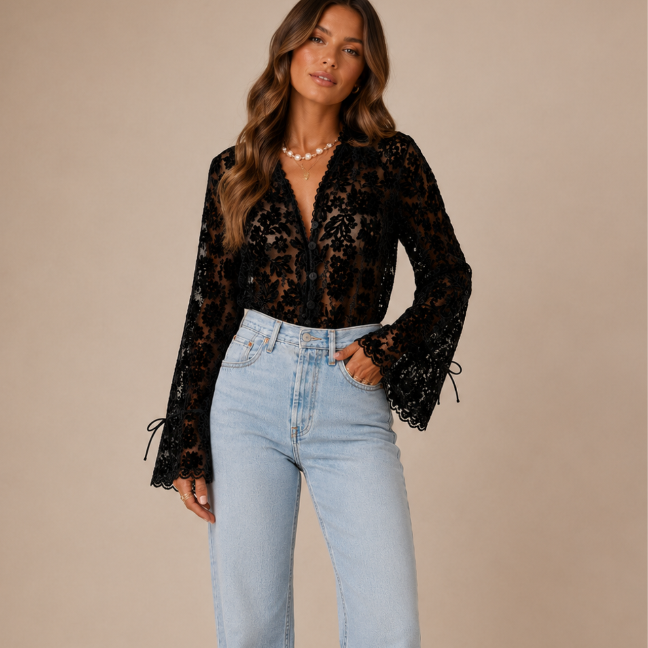 Overall view of Elia Floral Lace Long Sleeve Blouse in Black highlighting the floral lace pattern, V-neckline, and sleeve details designed by Bella Hudson.