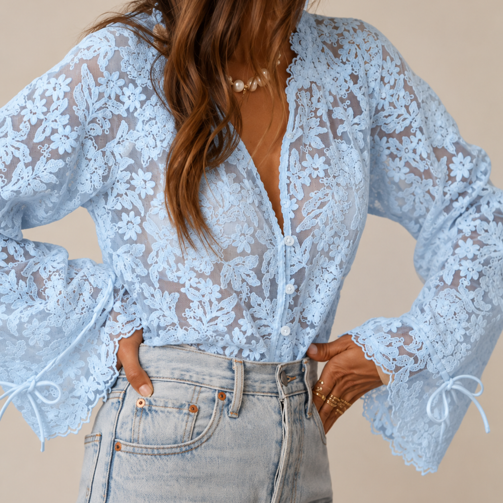 Detailed view of Elia Floral Lace Long Sleeve Blouse in sky blue highlighting the floral lace pattern, V-neckline, and sleeve details designed by Bella Hudson.