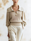 Elise Beige ribbed knit sweater with a wide spread collar and half-button placket, shown close up from the front with cream trousers.