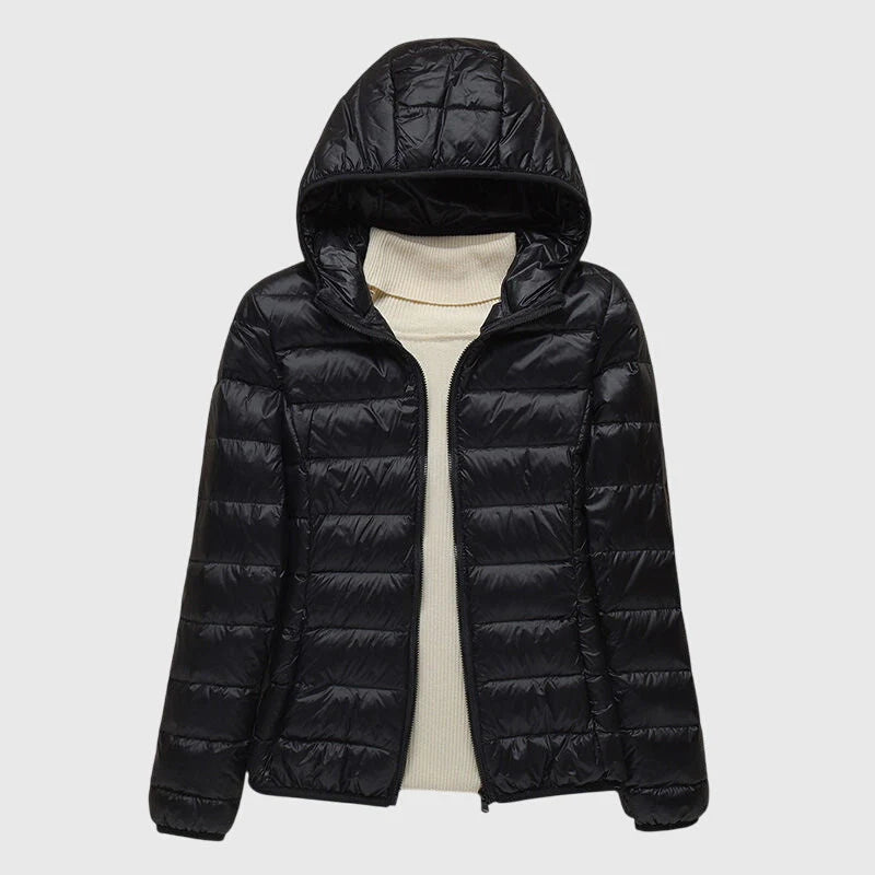 Elise Black lightweight puffer jacket featuring a quilted exterior, attached hood, full front zipper, and long sleeves