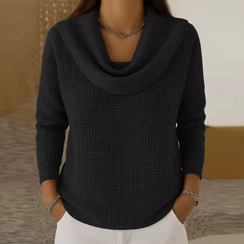 Elise Black waffle-knit sweater with a draped cowl neckline, long sleeves, and curved hem