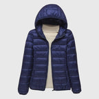 Elise Blue lightweight quilted puffer jacket featuring an attached hood, full front zipper, padded panels, and long sleeves