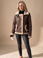 Elise Brown faux leather sherpa-trim jacket with wide buckled collar, button-front closure, long sleeves, and front patch pockets
