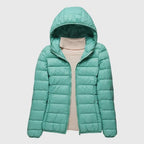 Elise Green hooded puffer jacket with horizontal quilted panels, zip-front closure, relaxed silhouette, and elasticated cuffs