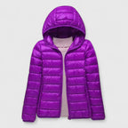 Elise Purple lightweight puffer jacket featuring a quilted exterior, attached hood, full front zipper, and long sleeves