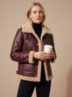 Elise Red faux leather sherpa-trim jacket with a wide contrast collar, button-front closure, long sleeves, and practical front pockets