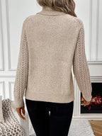 Eliza Khaki knit sweater with a relaxed silhouette and textured sleeves, shown from the back