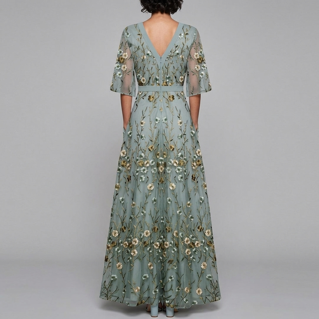 Back view of the Elodie Summer Maxi Dress Floral Print Wide Sleeve in green, highlighting the flowing floral skirt, flutter sleeves, and graceful full-length silhouette. Designed by Bella Hudson.