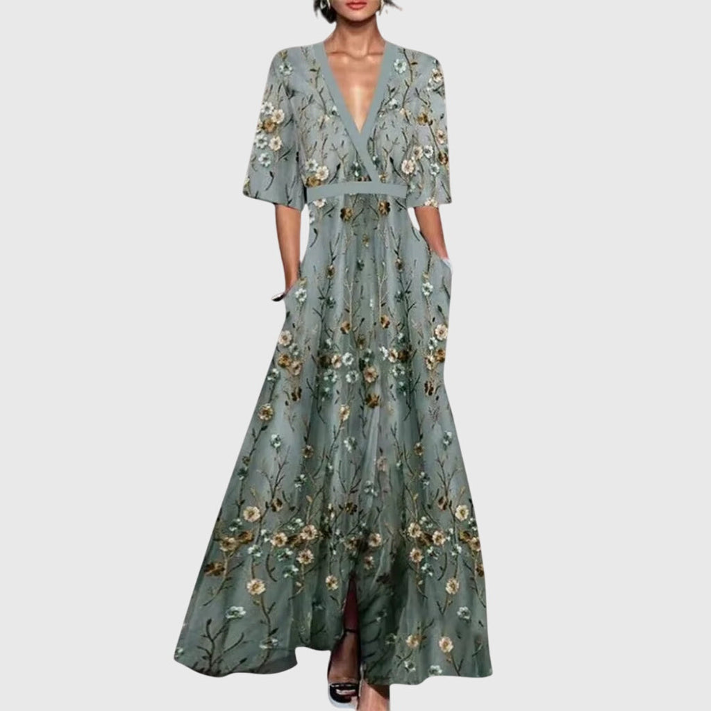 Front view of the Elodie Summer Maxi Dress Floral Print Wide Sleeve in green, featuring a wrap V-neckline, wide three-quarter sleeves, all-over floral print, and a flowing maxi silhouette. Designed by Bella Hudson.